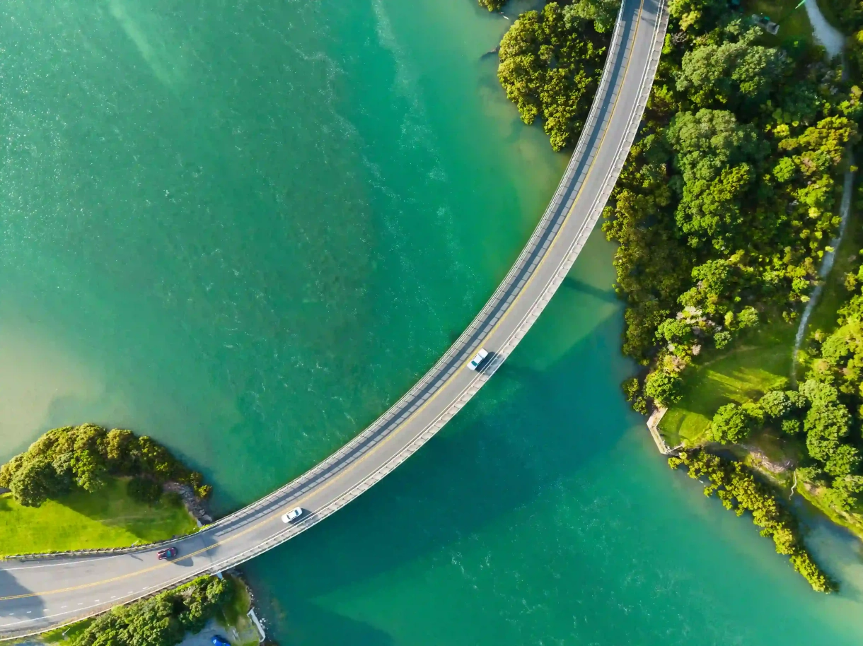 bridge above water with two cars